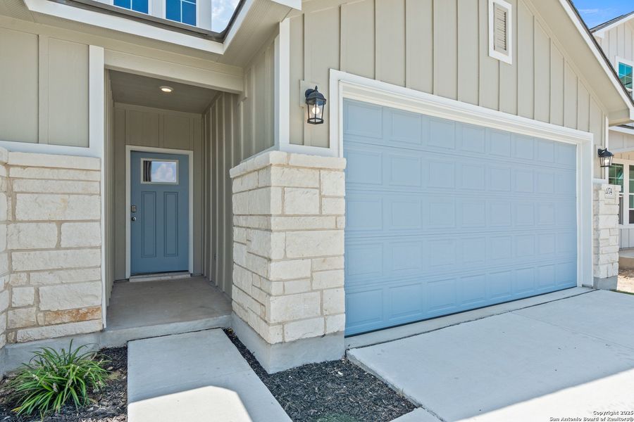 Front exterior of a new home in Weltner Farms 50’s, New Braunfels, TX, highlighting curb appeal (Image 2). Front exterior of a new home in Weltner Farms 50’s, New Braunfels, TX, highlighting curb appeal (Image 2).