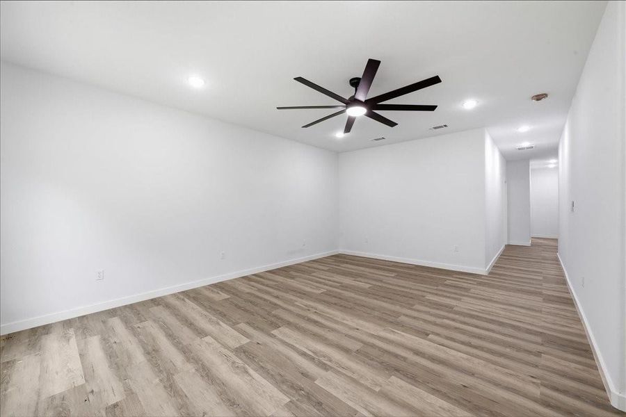Additional spacious bedroom with a modern ceiling fan and recessed lighting. Additional spacious bedroom with a modern ceiling fan and recessed lighting.