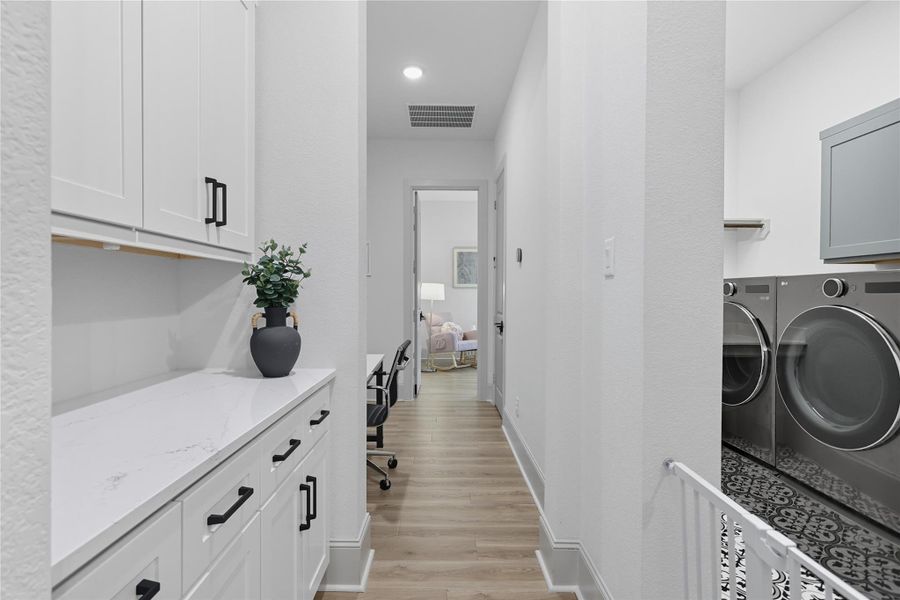 Hallway to secondary bedrooms. Custom selves and desk area. Hallway to secondary bedrooms. Custom selves and desk area.