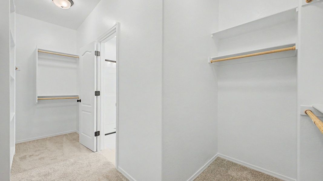 Primary walk-in closet in move-in ready Clover home by DRB Homes at Sienna Park, 1315 S. 215th Drive, Buckeye, Arizona 85326. Primary walk-in closet in move-in ready Clover home by DRB Homes at Sienna Park, 1315 S. 215th Drive, Buckeye, Arizona 85326.