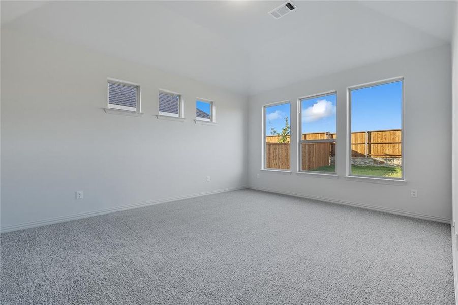 Carpeted empty room featuring baseboards Carpeted empty room featuring baseboards