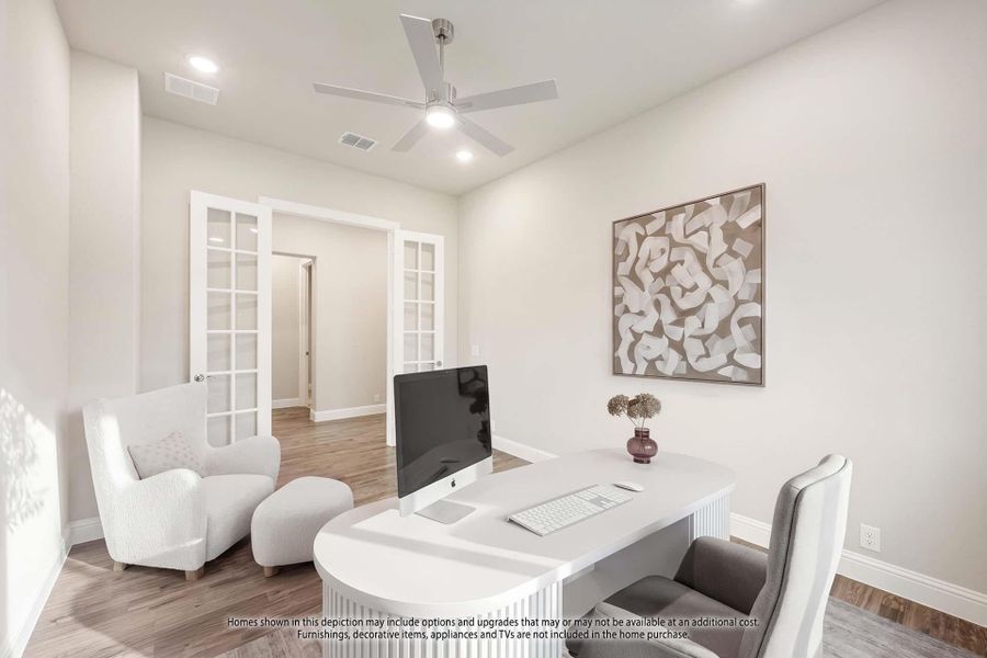 Home office with white desk, ceiling fan, hardwood floors, and French doors leading to hallway