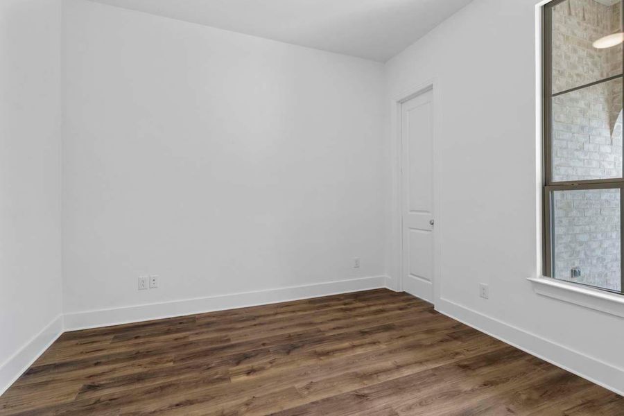 Spare room featuring dark wood finished floors and baseboards Spare room featuring dark wood finished floors and baseboards