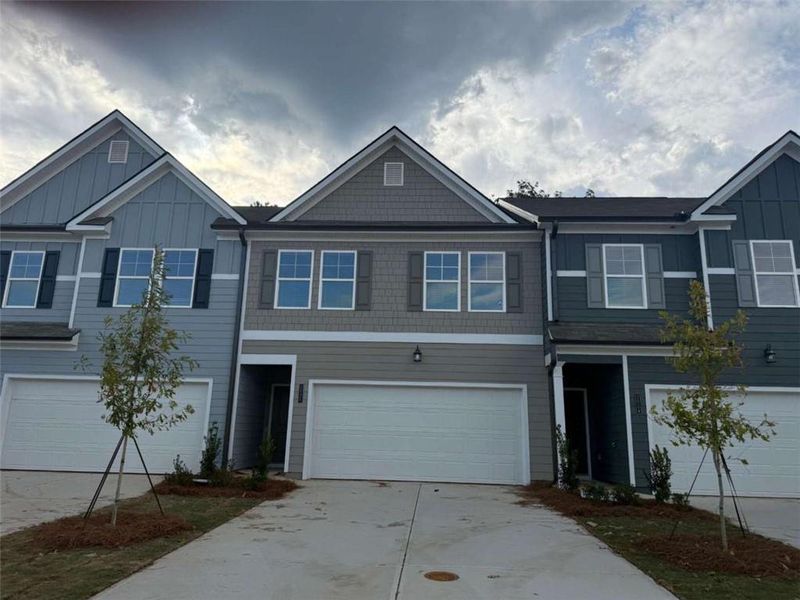 Front exterior of a new home in Rivershire Place, Villa Rica, GA, highlighting curb appeal (Image 2).