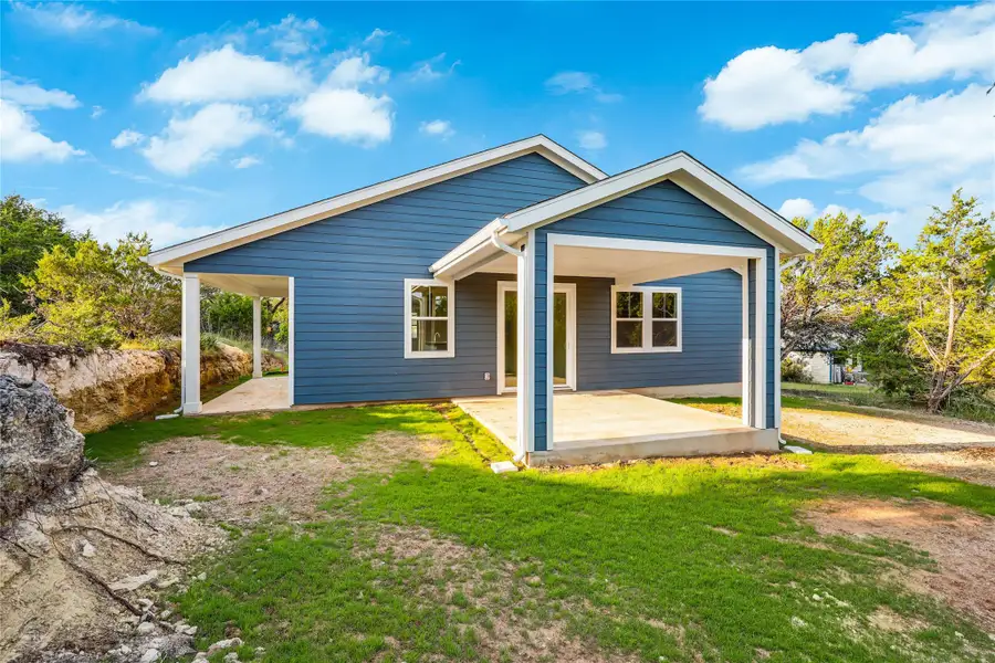 View of front of home with a patio and a front yard View of front of home with a patio and a front yard