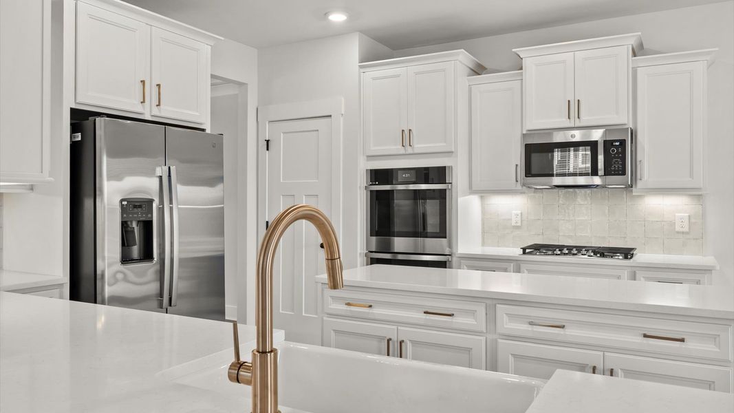 Elegant kitchen featuring a functional island and clean, current styling throughout Elegant kitchen featuring a functional island and clean, current styling throughout