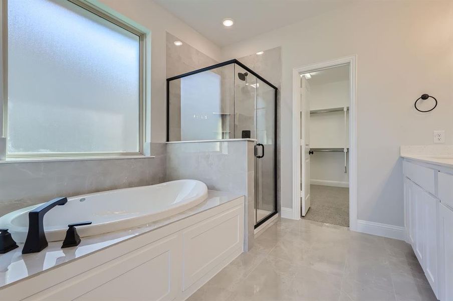 Bathroom with vanity and separate shower and tub