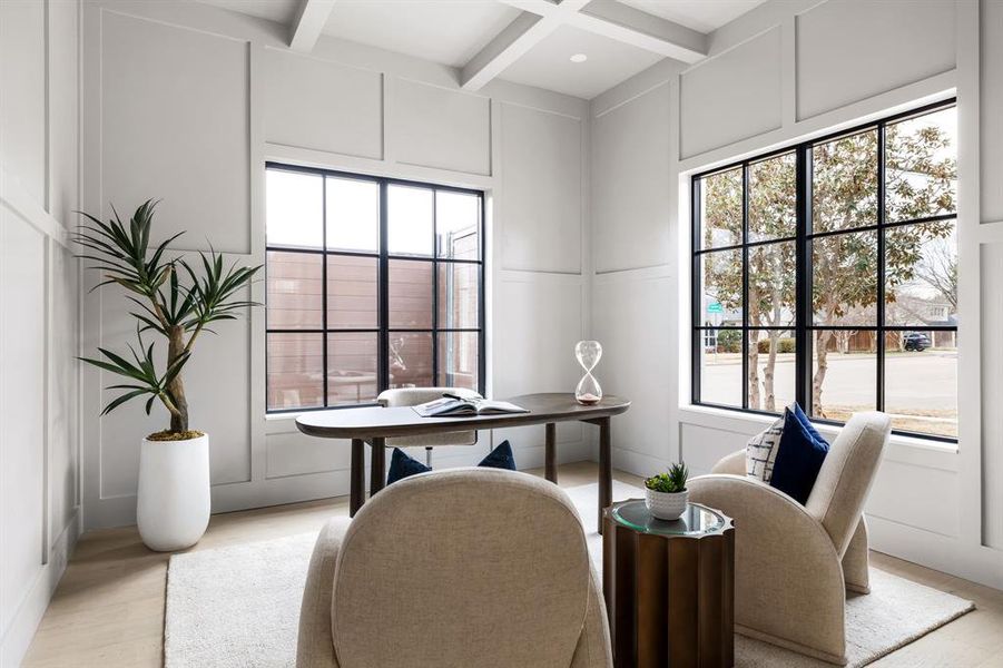 Office space featuring light wood-type flooring, beam ceiling, coffered ceiling, and a decorative wall