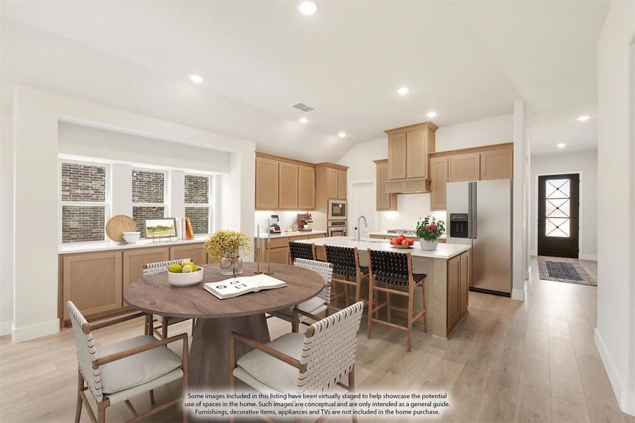 Open kitchen and dining area with light wood cabinets, center island, and round dining table on hardwood floors Open kitchen and dining area with light wood cabinets, center island, and round dining table on hardwood floors