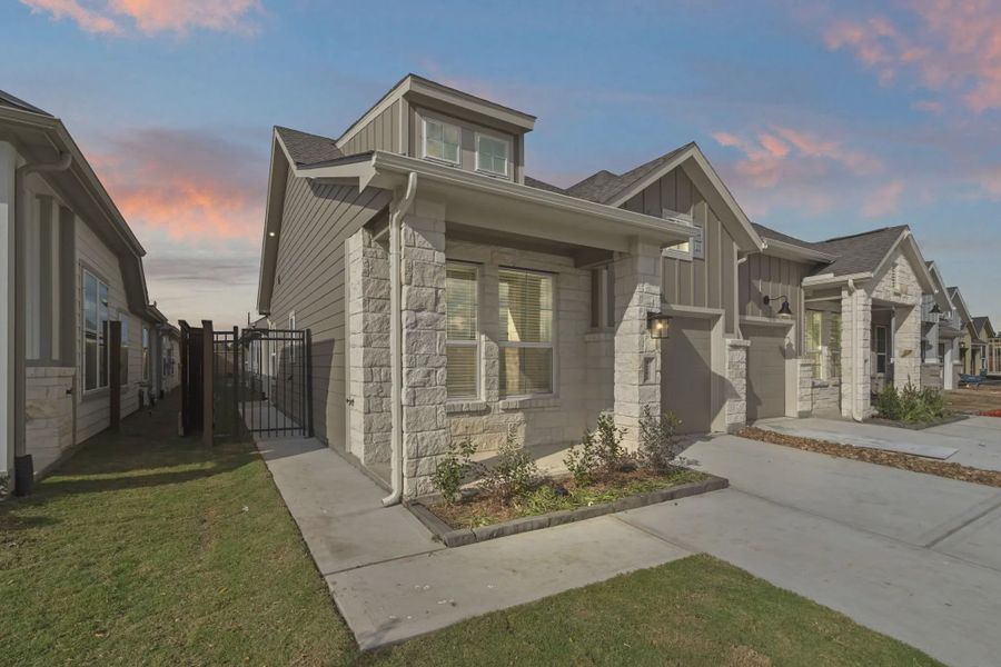 Representative exterior photo of a completed home built from the Carriagehouse by Chesmar Homes in Meridiana Townhomes, Iowa Colony, TX (Image 35).