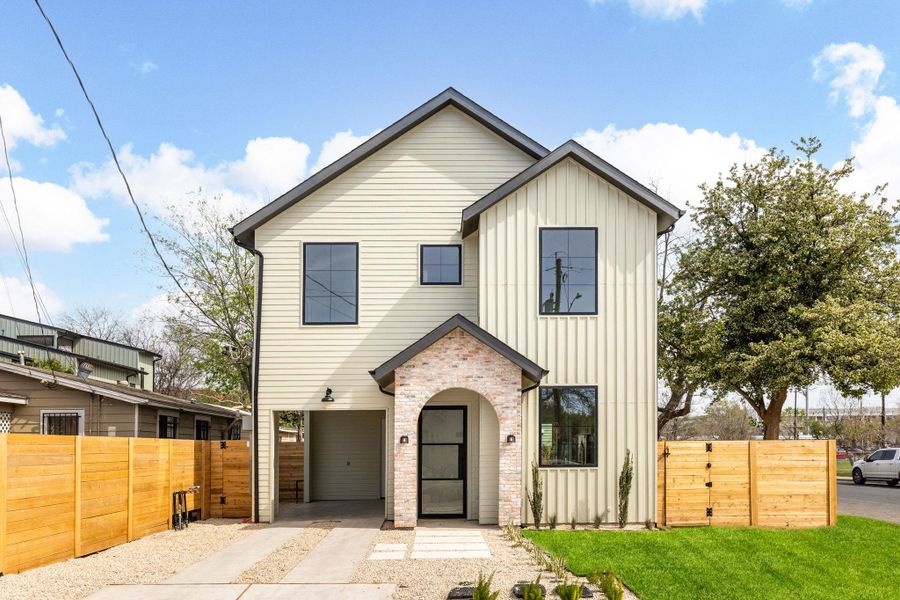 View of front facade featuring board and batten siding, a garage, and a gate View of front facade featuring board and batten siding, a garage, and a gate