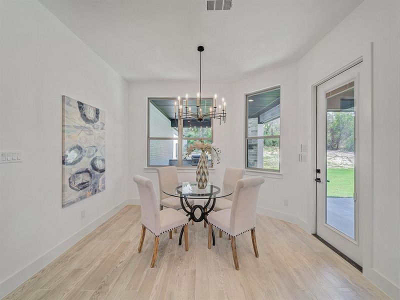 Dining room featuring a chandelier and light wood-style flooring