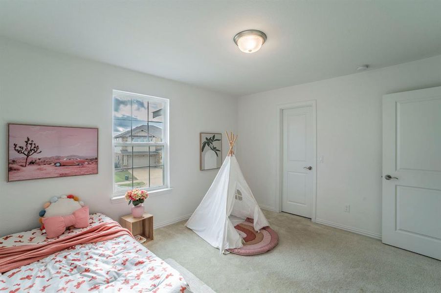 Bedroom with light colored carpet and baseboards Bedroom with light colored carpet and baseboards