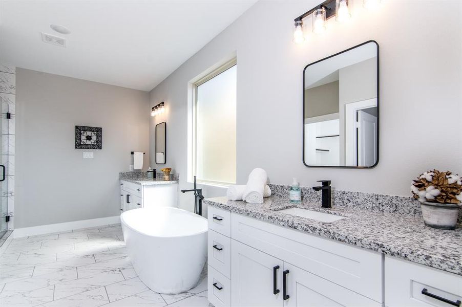 Primary bath with double granite vanities, and large soaking tub.