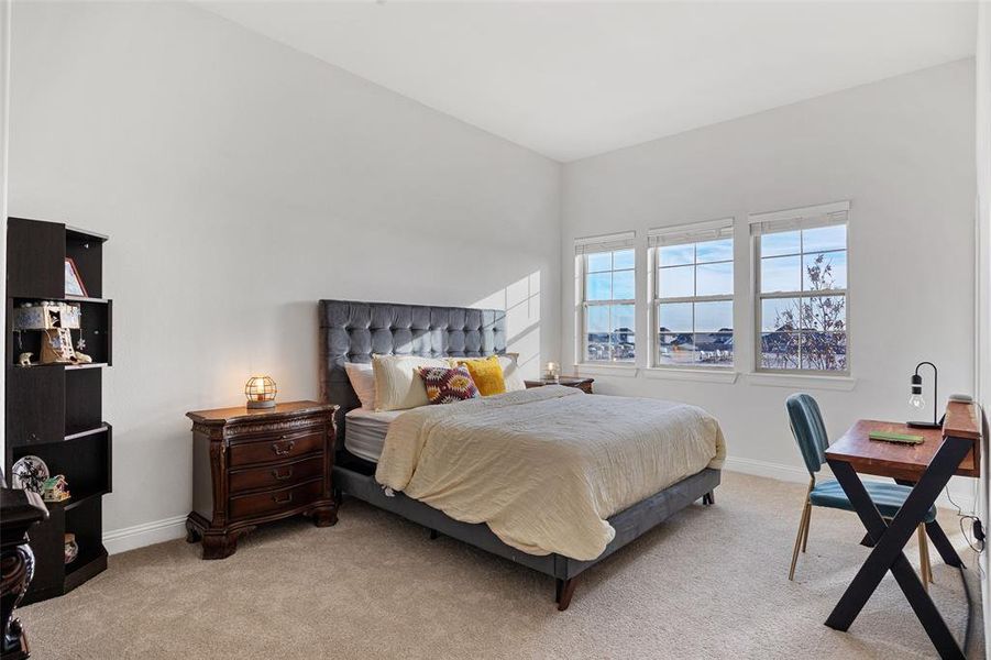 Bedroom featuring light colored carpet and baseboards