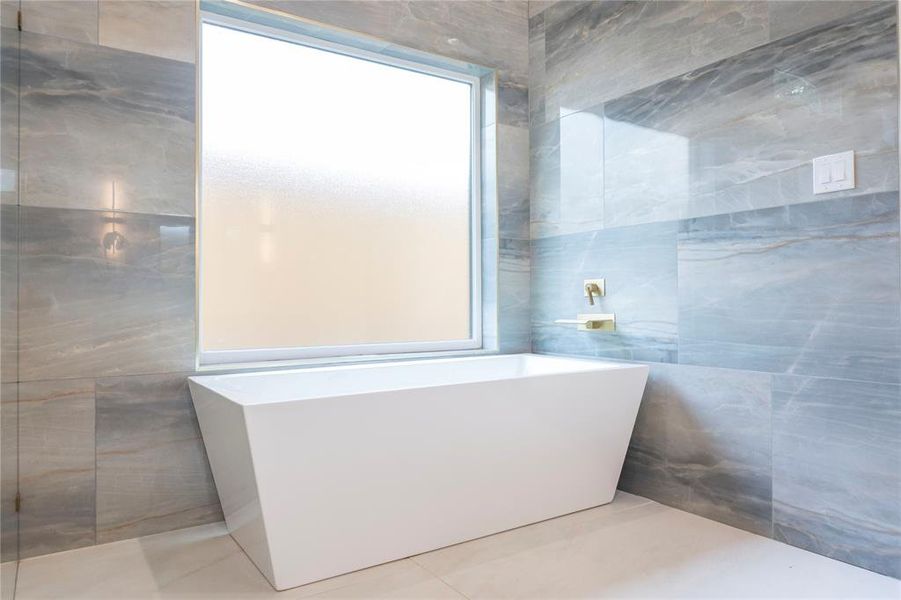 Bathroom with tile floors and tile walls