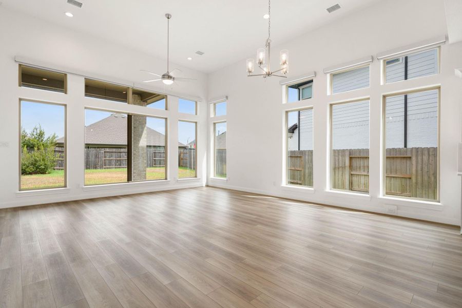 Wall to wall windows in the family room are amazing! Automatic blinds have been installed for privacy and easy opening and closing.