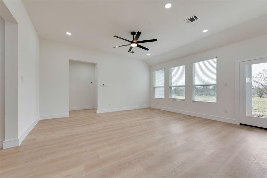 Unfurnished room with ceiling fan and light hardwood / wood-style floors