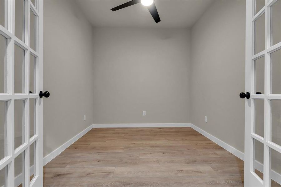 Spare room with ceiling fan and light hardwood / wood-style floors