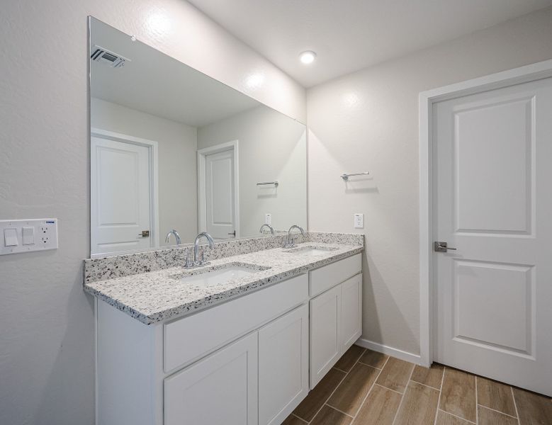 A bathroom with a marble countertop.