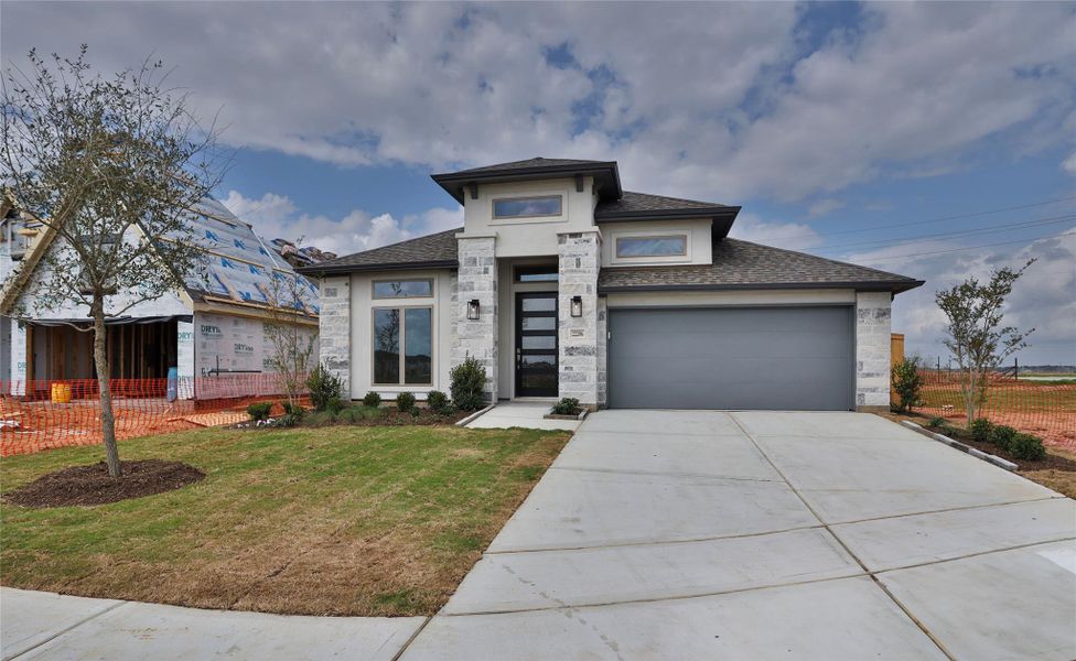 Front exterior of a new home in Everly, Tomball, TX, highlighting curb appeal (Image 2).