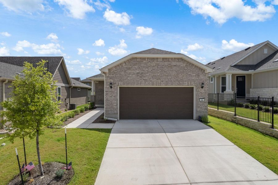 Front exterior of a new home in Sun City Texas, Georgetown, TX, highlighting curb appeal (Image 18).