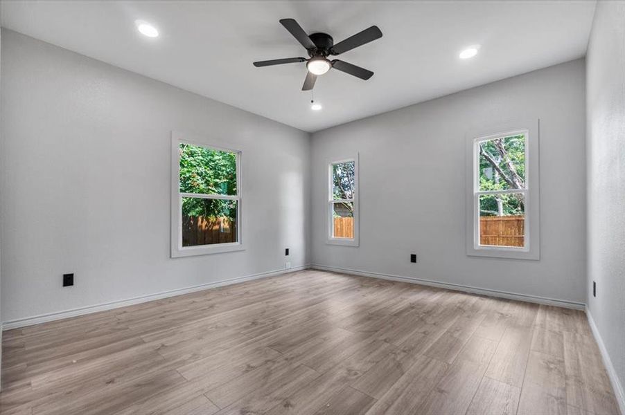 Empty room featuring light hardwood / wood-style flooring and ceiling fan