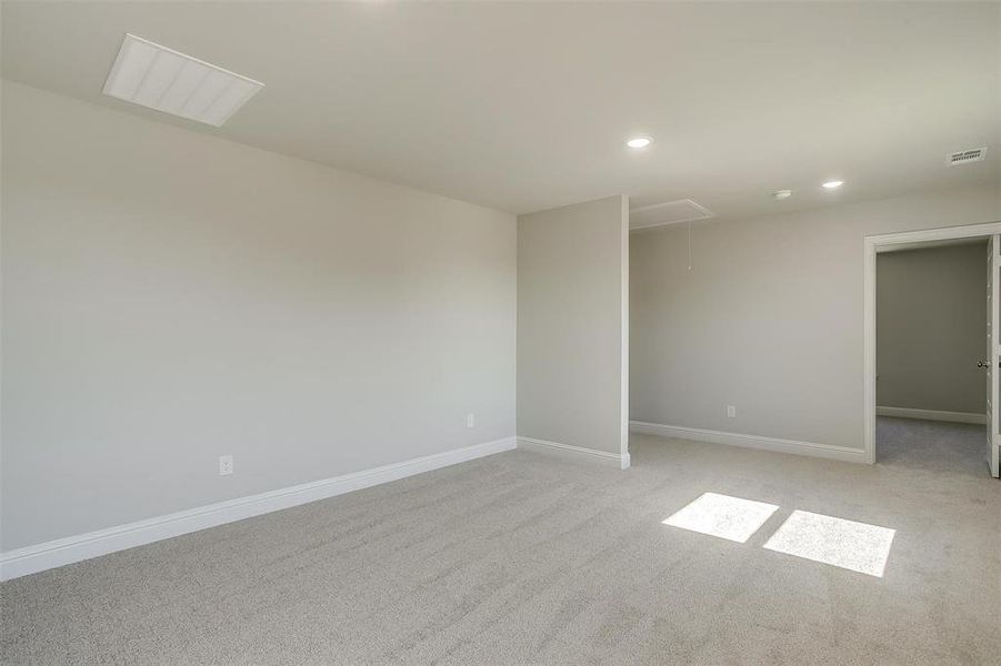 Spare room featuring attic access, light carpet, and recessed lighting Spare room featuring attic access, light carpet, and recessed lighting
