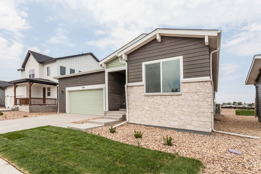 Front exterior of a new home in Prairie Song, Windsor, CO, highlighting curb appeal (Image 2). Front exterior of a new home in Prairie Song, Windsor, CO, highlighting curb appeal (Image 2).