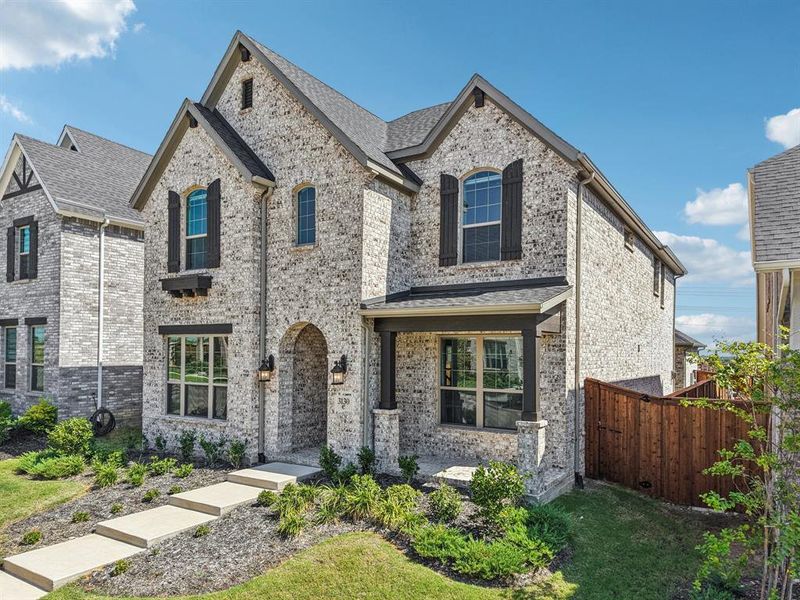French country style house featuring brick siding French country style house featuring brick siding
