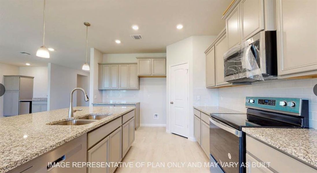 Kitchen featuring tasteful backsplash, visible vents, appliances with stainless steel finishes, and a sink Kitchen featuring tasteful backsplash, visible vents, appliances with stainless steel finishes, and a sink