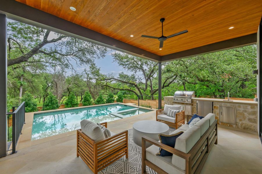 Entertain guests poolside with an outdoor kitchen, covered patio, and serene wooded views. Entertain guests poolside with an outdoor kitchen, covered patio, and serene wooded views.