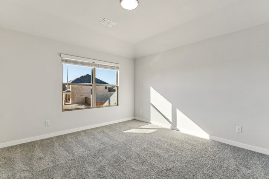 Bedroom in the Wimbledon home plan by Trophy Signature Homes – REPRESENTATIVE PHOTO