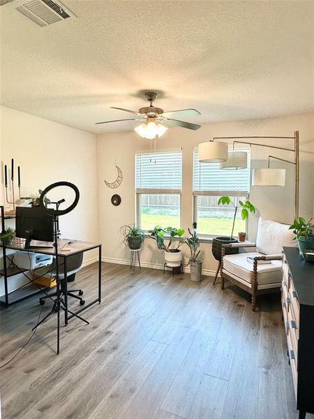 Home office or second living area featuring a textured ceiling, light wood-style floors, and ceiling fan Home office or second living area featuring a textured ceiling, light wood-style floors, and ceiling fan