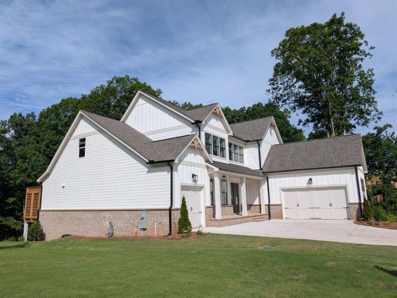 Front exterior of a new home in White Post on Lake Lanier, Gainesville, GA, highlighting curb appeal (Image 26). Front exterior of a new home in White Post on Lake Lanier, Gainesville, GA, highlighting curb appeal (Image 26).