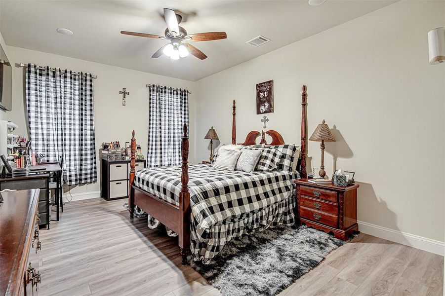 Bedroom with ceiling fan and light hardwood / wood-style floors