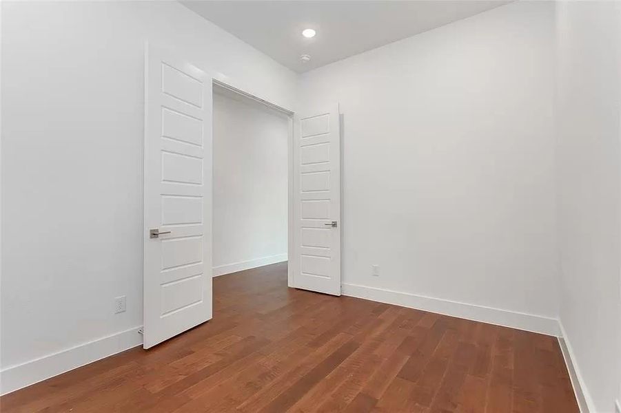 Unfurnished room with dark wood-type flooring