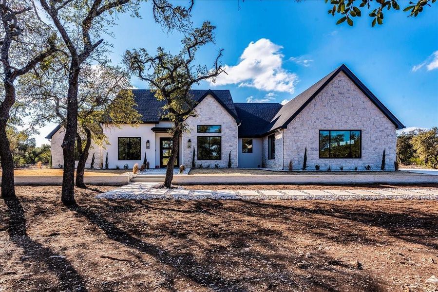 This custom-designed single-story home covers over 2,900 sq.ft. and is nestled on a peaceful 2.86-acre lot featuring mature trees.