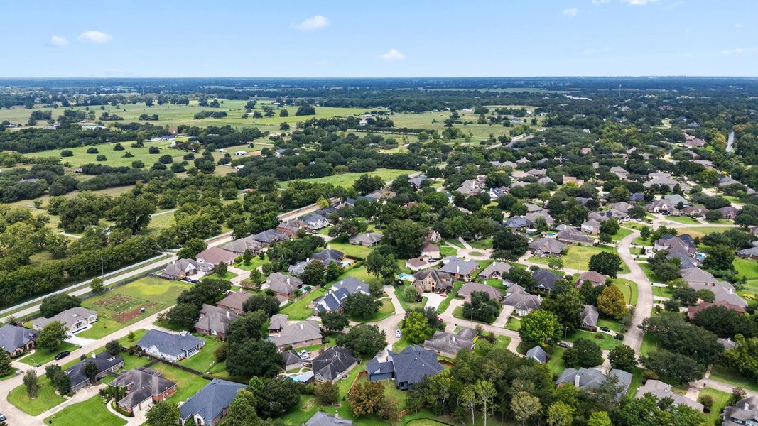 This aerial photo showcases a spacious suburban neighborhood with well-maintained homes, lush greenery, and winding streets. The area is surrounded by open fields, offering a peaceful, rural feel while maintaining a sense of community. This aerial photo showcases a spacious suburban neighborhood with well-maintained homes, lush greenery, and winding streets. The area is surrounded by open fields, offering a peaceful, rural feel while maintaining a sense of community.