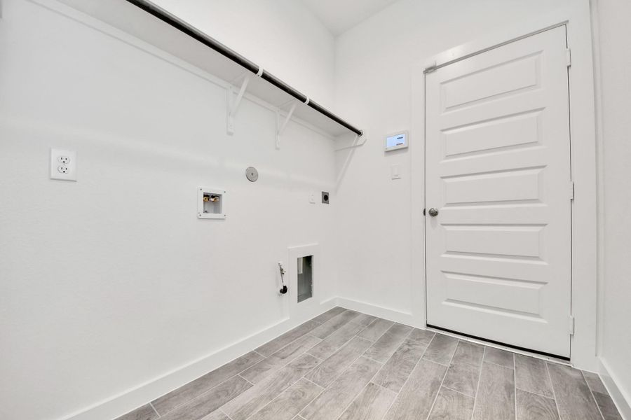 A perfect blend of functionality and comfort. Capture the essence of easy living with a first-floor laundry room, thoughtfully equipped with shelving for effortless organization. Both electric and gas connections available.