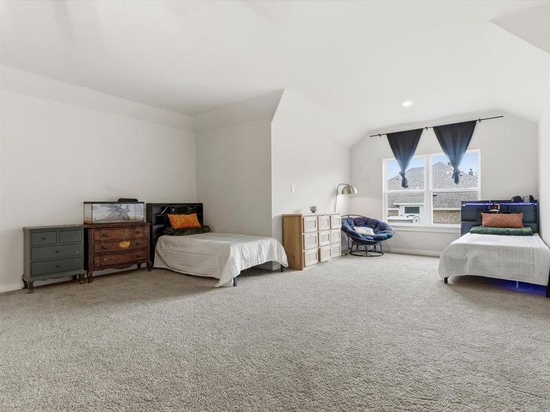 Versatile bonus room upstairs with en-suite bathroom, perfect for large second primary, media room, game room, or additional living space.