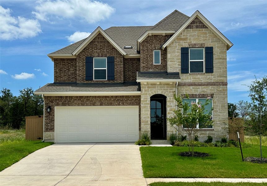 Front exterior of a new home in The Colony 50', Bastrop, TX, highlighting curb appeal (Image 1).