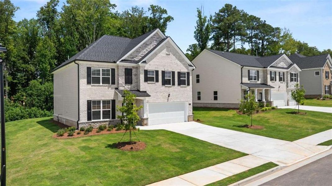 Front exterior of a new home in Independence, Loganville, GA, highlighting curb appeal (Image 1). Front exterior of a new home in Independence, Loganville, GA, highlighting curb appeal (Image 1).