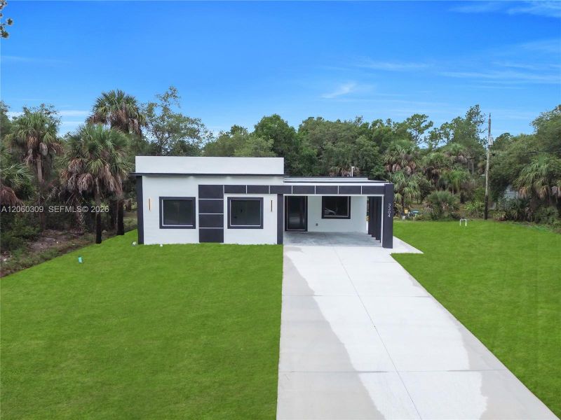 Front exterior of a new home in , Lehigh Acres, FL, highlighting curb appeal (Image 26).