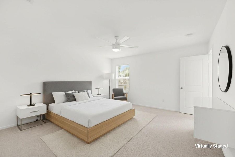 Virtually staged bedroom showcases a spacious footprint with neutral carpeting, ceiling fan, window for natural light, and room for additional furnishings. Virtually staged bedroom showcases a spacious footprint with neutral carpeting, ceiling fan, window for natural light, and room for additional furnishings.