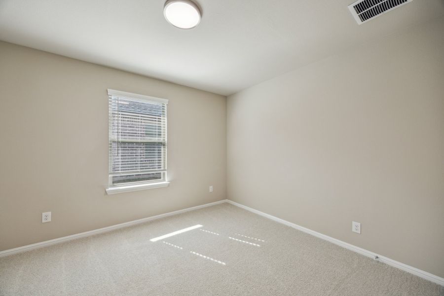 Bedroom in the Harper home plan by Trophy Signature Homes – REPRESENTATIVE PHOTO