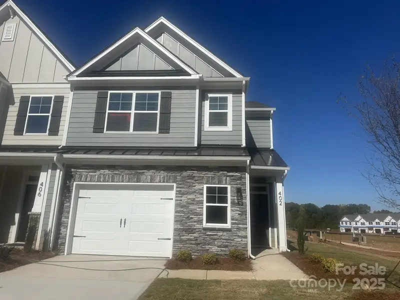 Front exterior of a new home in , Waxhaw, NC, highlighting curb appeal (Image 1).