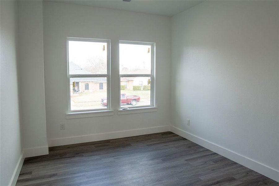 Empty room with dark wood-type flooring