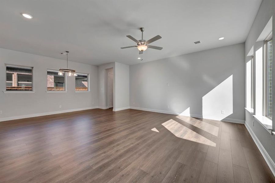 Spare room with recessed lighting, a ceiling fan, and dark wood-style flooring