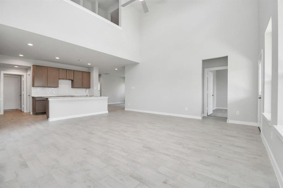 Another view of the living room area, heart of the home. Sample photo of completed home. Actual colors and selections may vary.